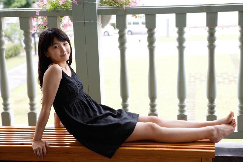 woman in black dress on bench