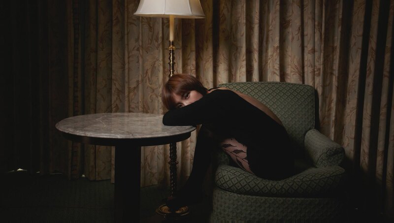 woman in black dress on chair