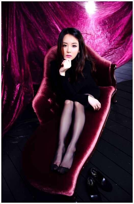 woman in black dress on chaise lounge