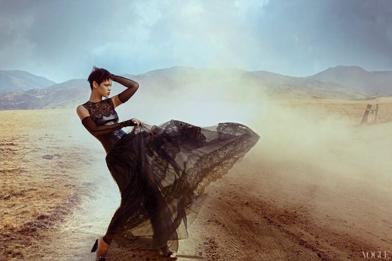 Woman in black dress on dusty road