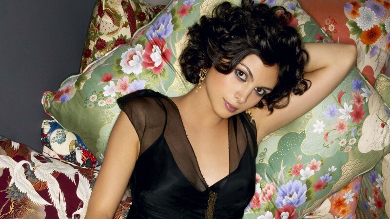 woman in black dress on floral pillows