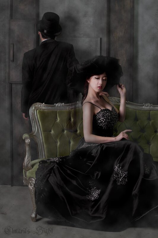 woman in black dress on green couch