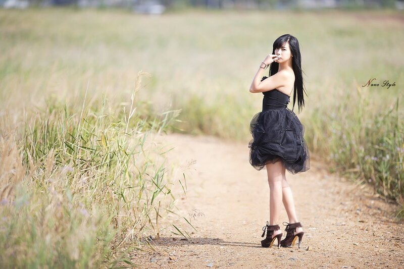 Woman in black dress on path