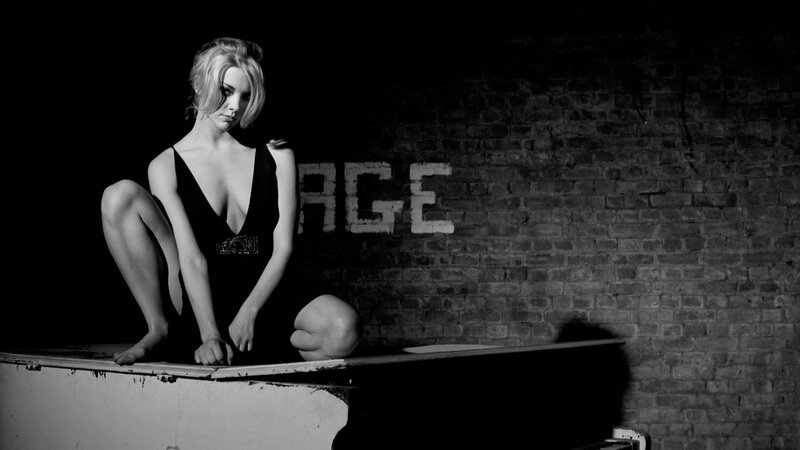woman in black dress on piano