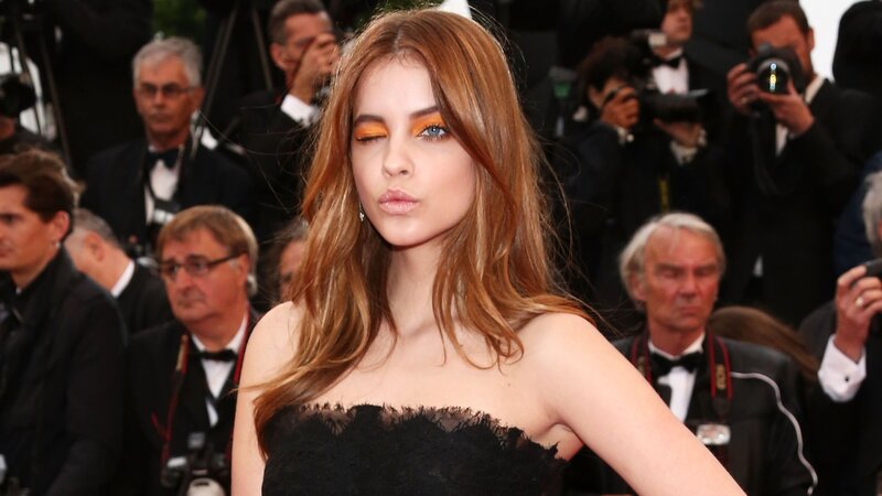 woman in black dress on red carpet