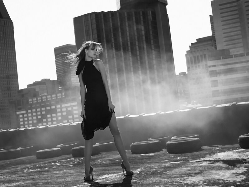 Woman in black dress on rooftop