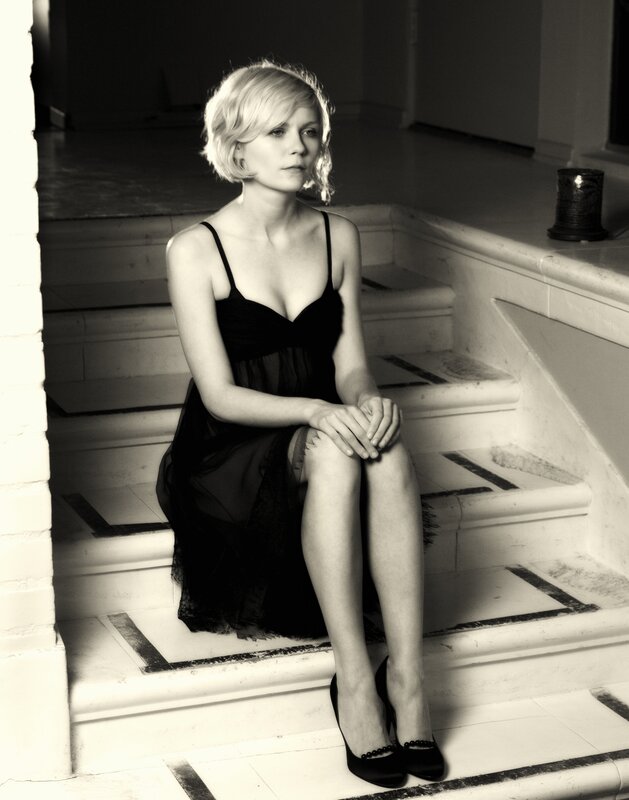 woman in black dress on stairs