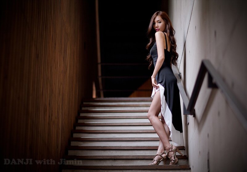 woman in black dress on stairs