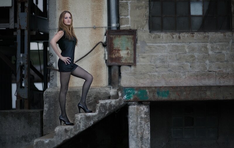 woman in black dress on stairs