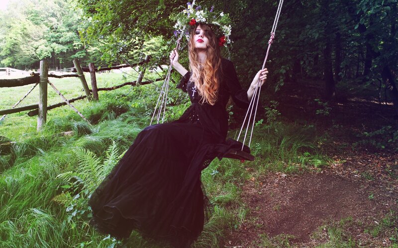 Woman in black dress on swing