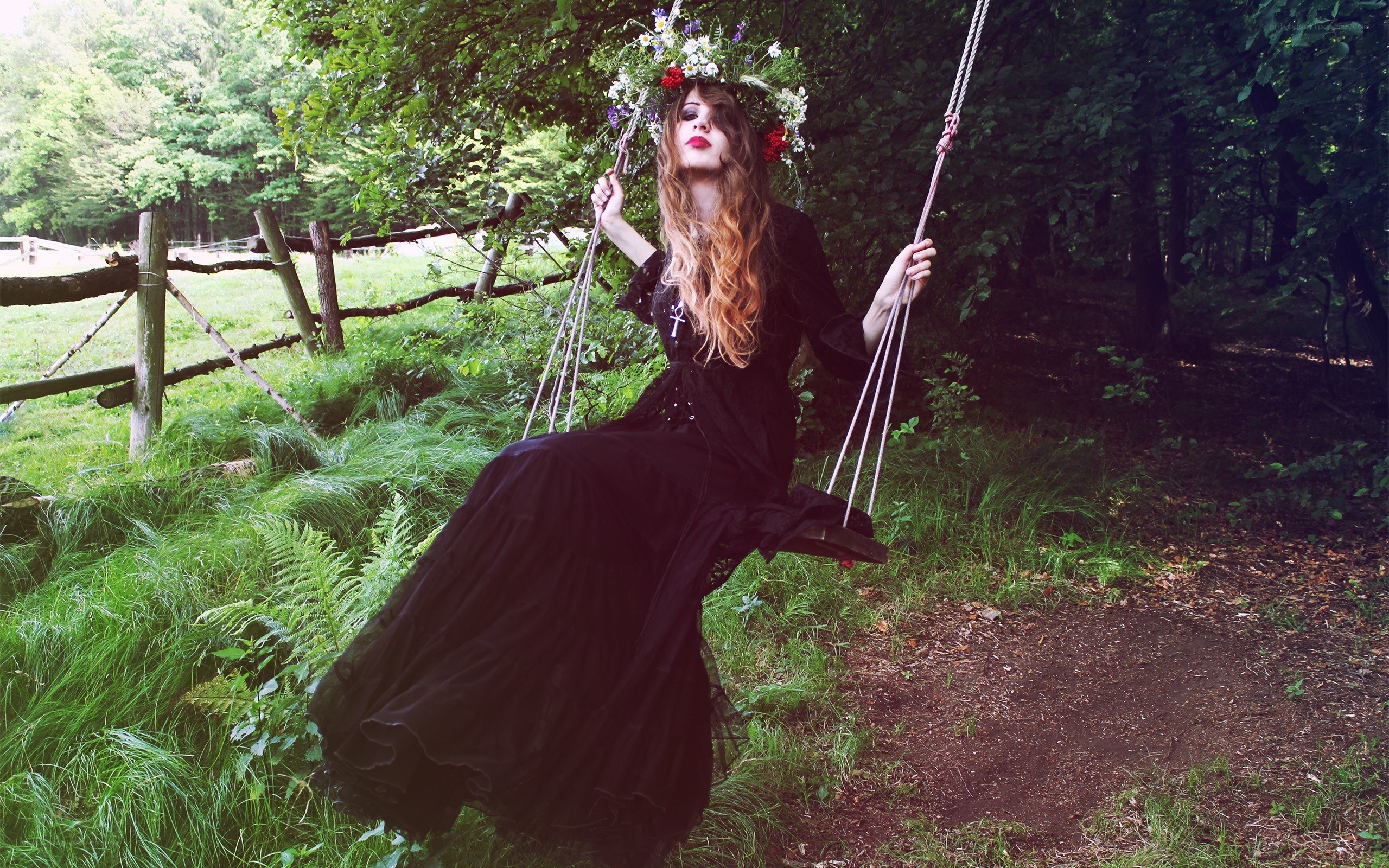 Woman in black dress on swing