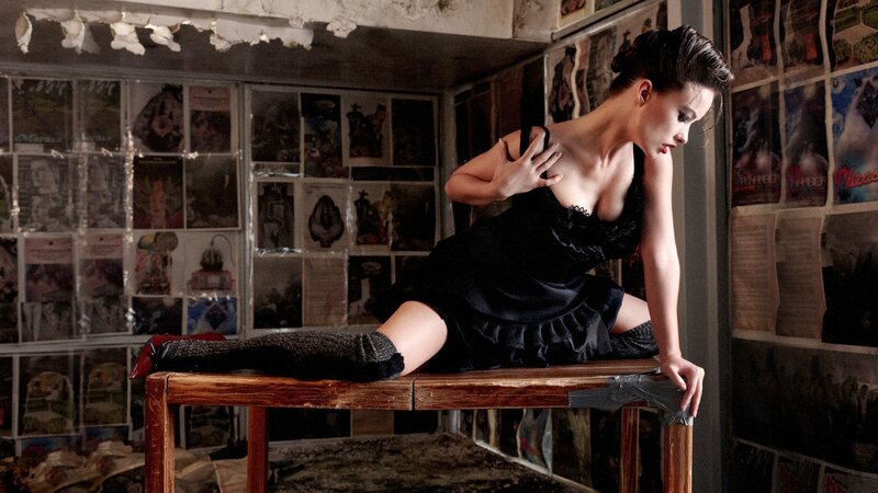 woman in black dress on table