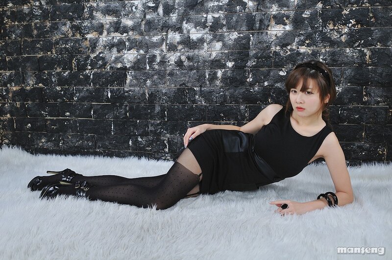 woman in black dress on white rug