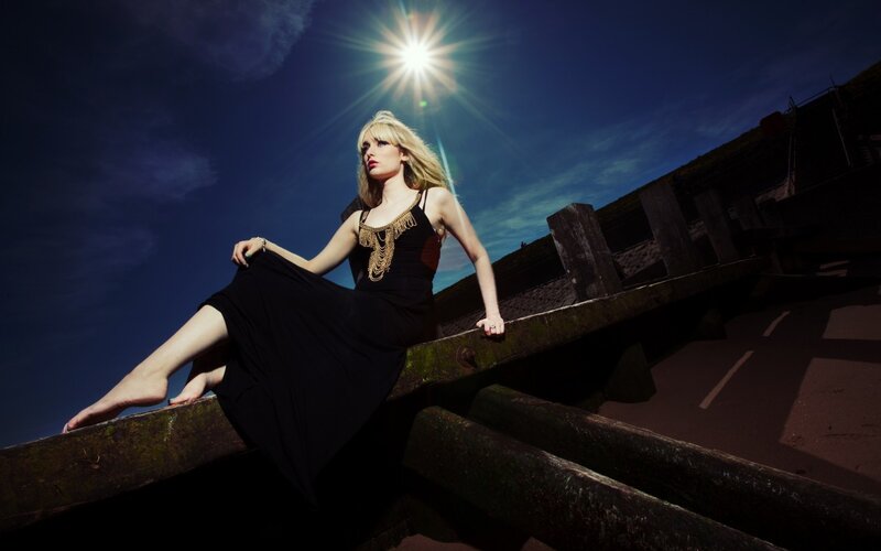 Woman in black dress on wooden structure