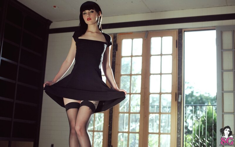 woman in black dress posing