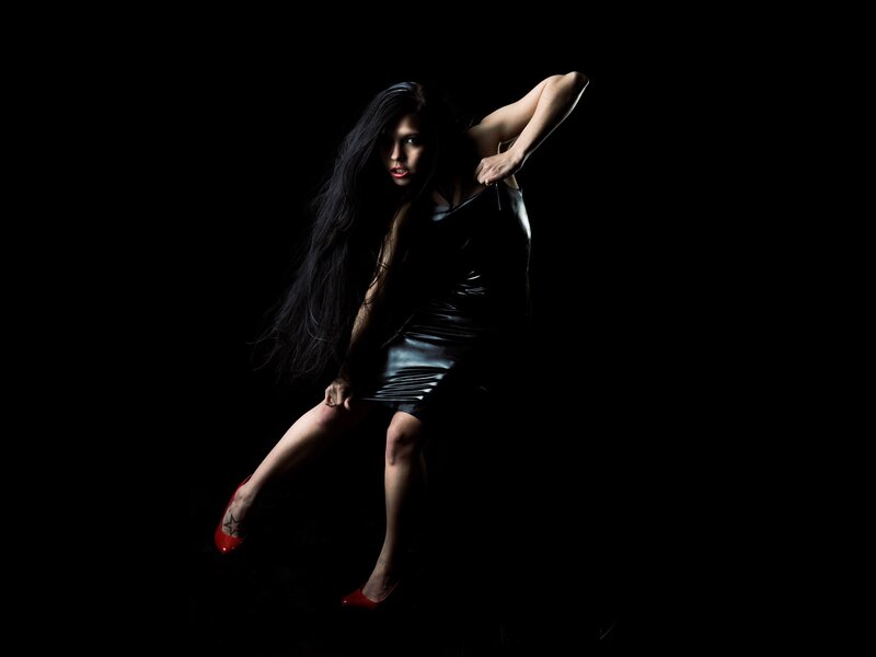woman in black dress posing