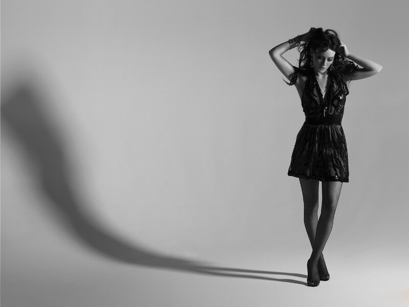 woman in black dress posing