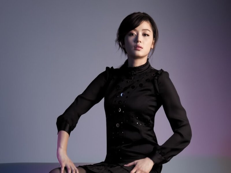 woman in black dress posing