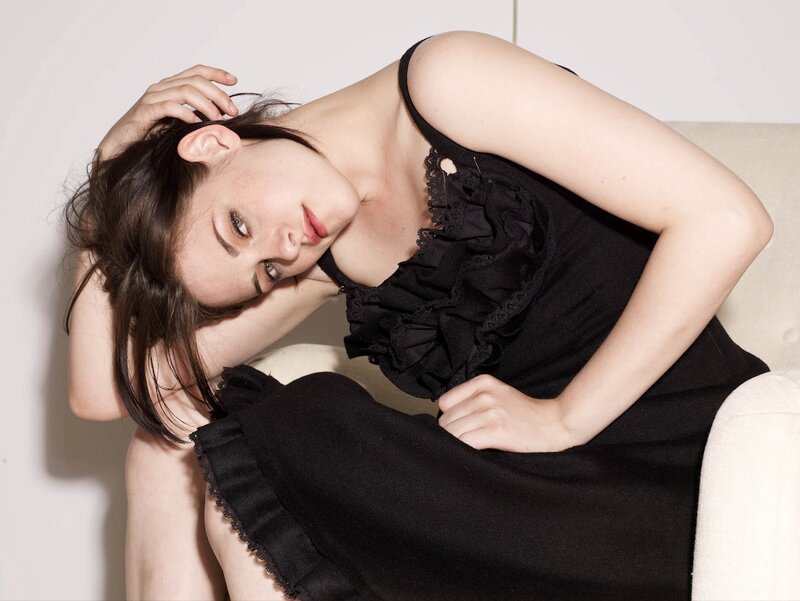 woman in black dress posing