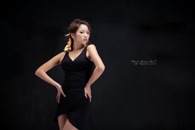 woman in black dress posing