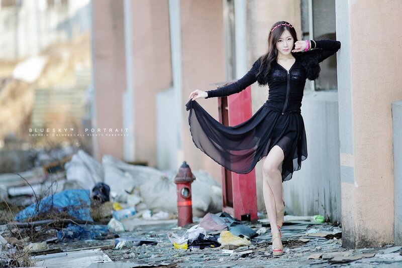 Woman in black dress posing
