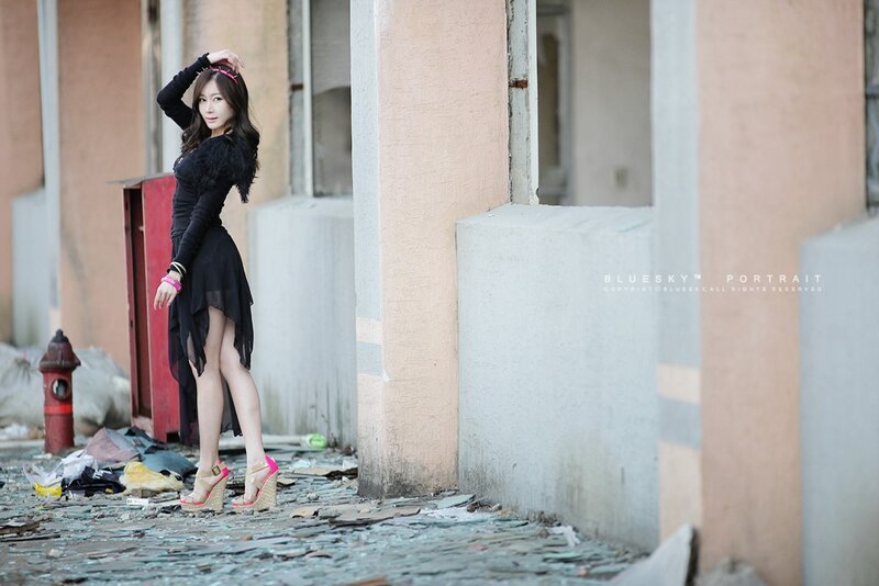 woman in black dress posing