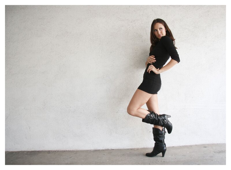 woman in black dress posing