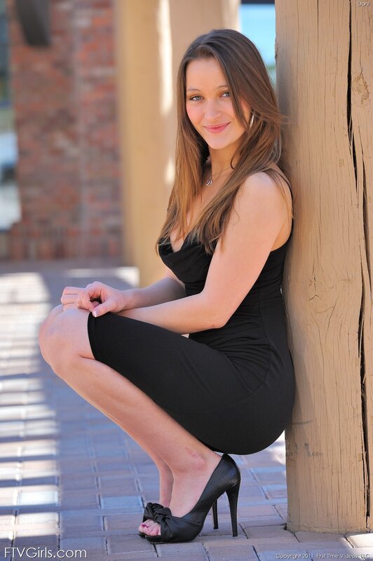 Woman in Black Dress — Relaxed, Afternoon, Photograph, High Heels, Wooden Post