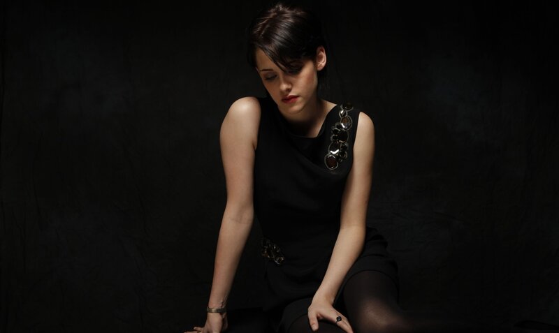 woman in black dress sitting