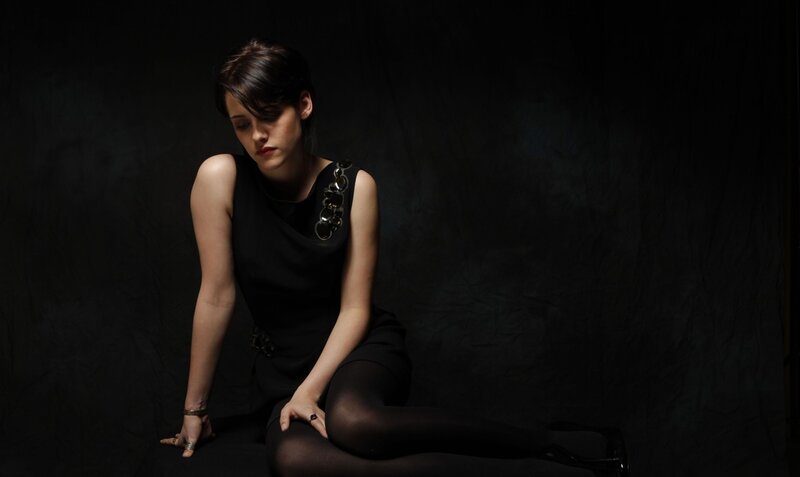woman in black dress sitting