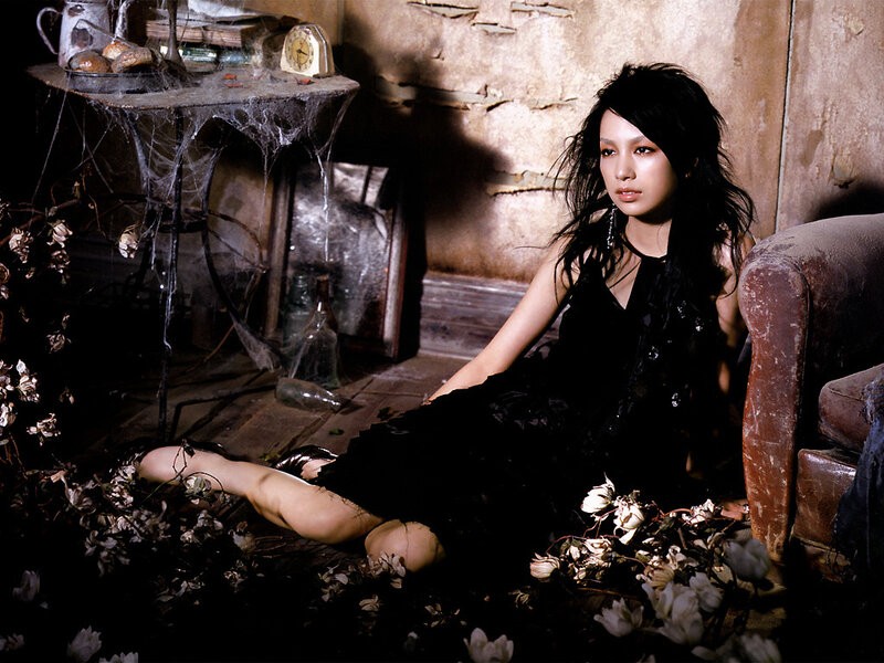 woman in black dress sitting on floor