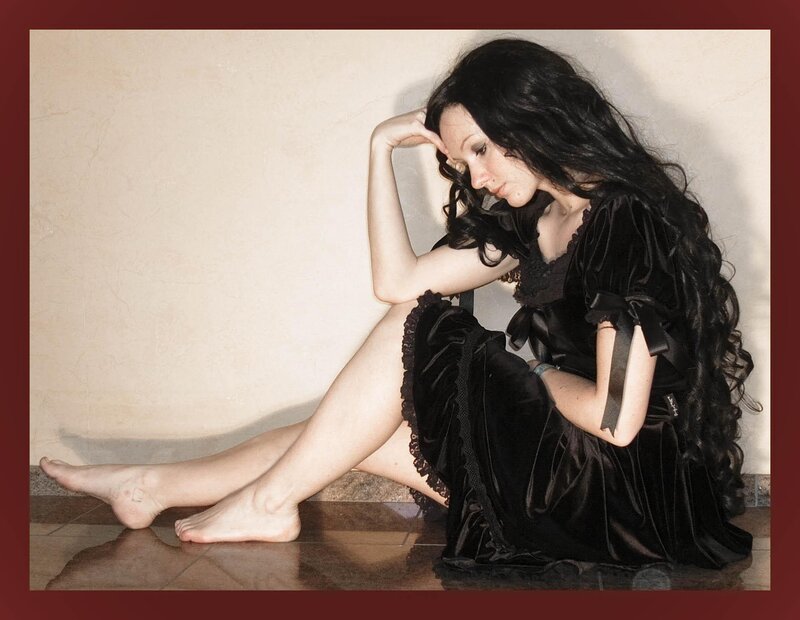 woman in black dress sitting on floor