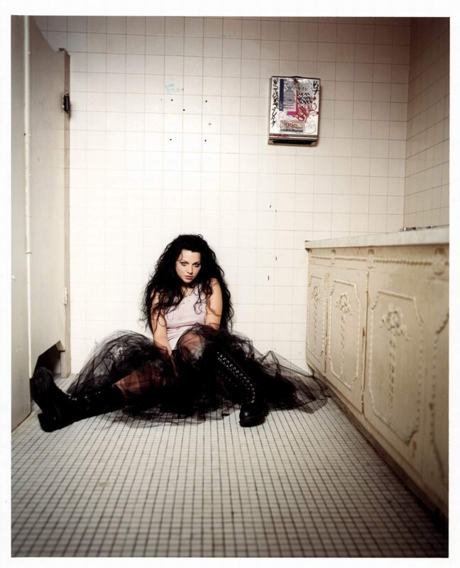 woman in black dress sitting on floor