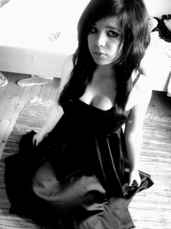 woman in black dress sitting on floor