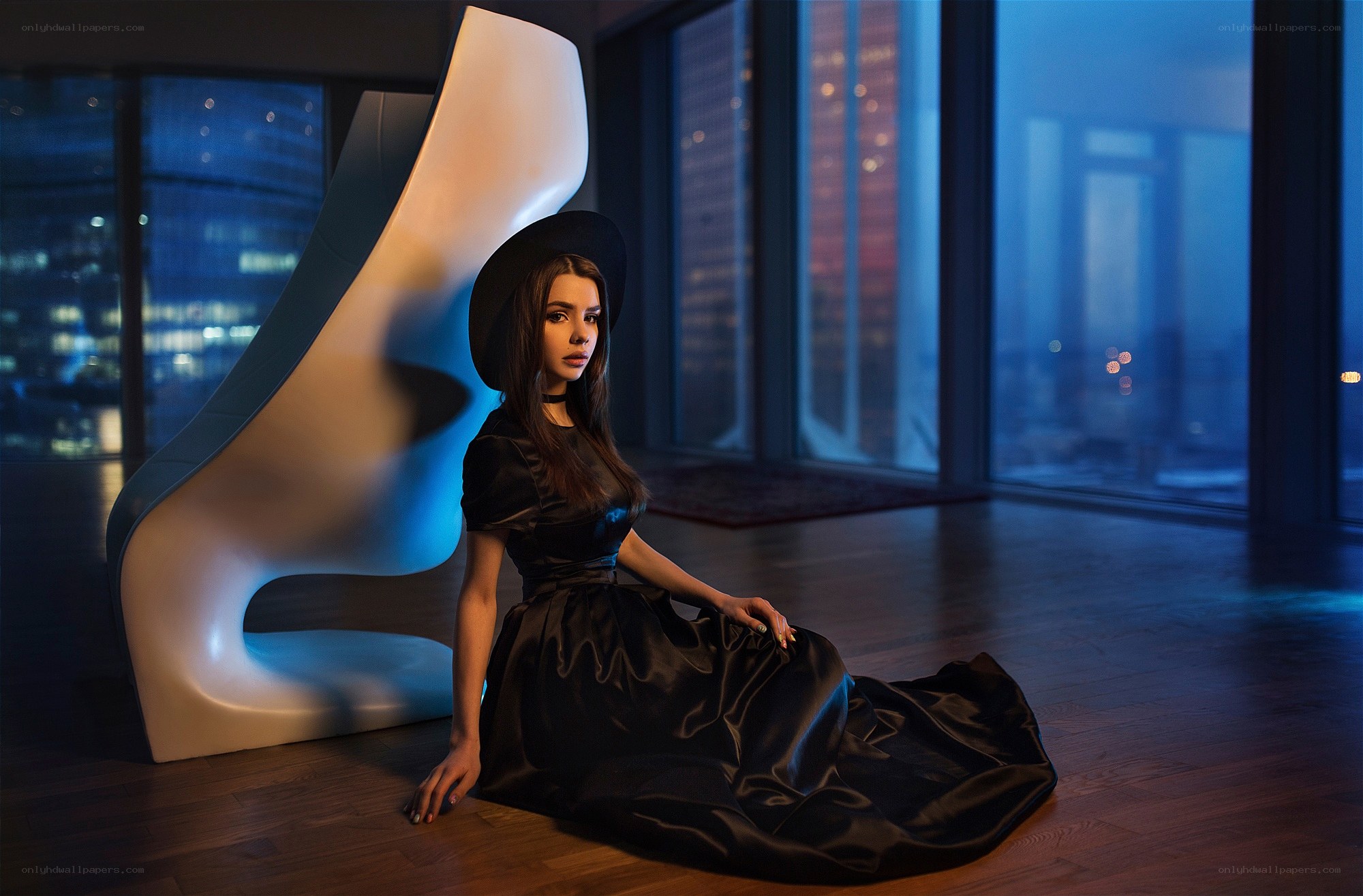 woman in black dress sitting on floor