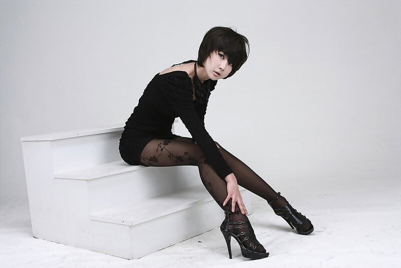 woman in black dress sitting on stairs