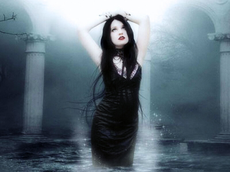 woman in black dress standing in water