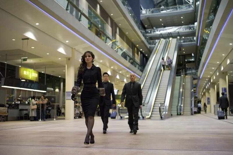 Woman in black dress walking through airport