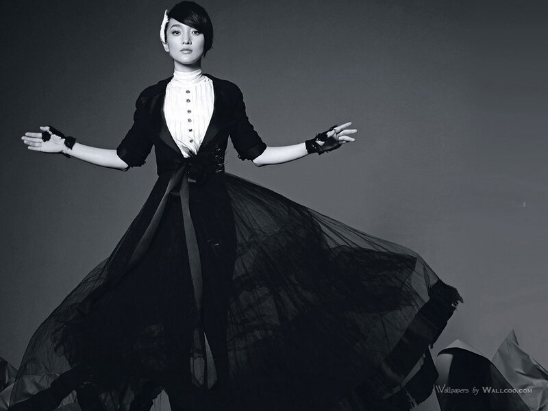 woman in black dress with arms outstretched