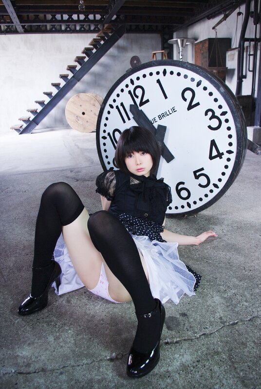 Woman in black dress with clock