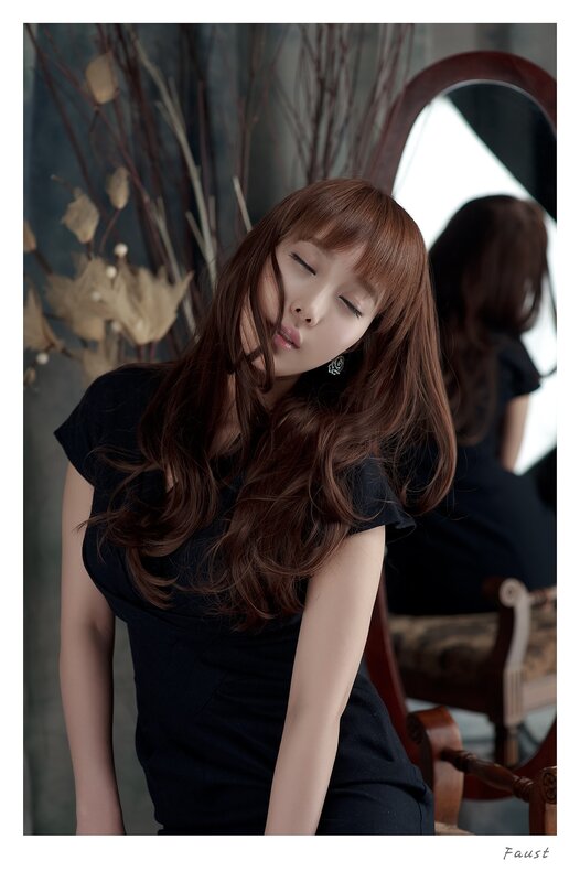woman in black dress with closed eyes