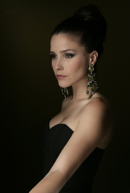 woman in black dress with earrings