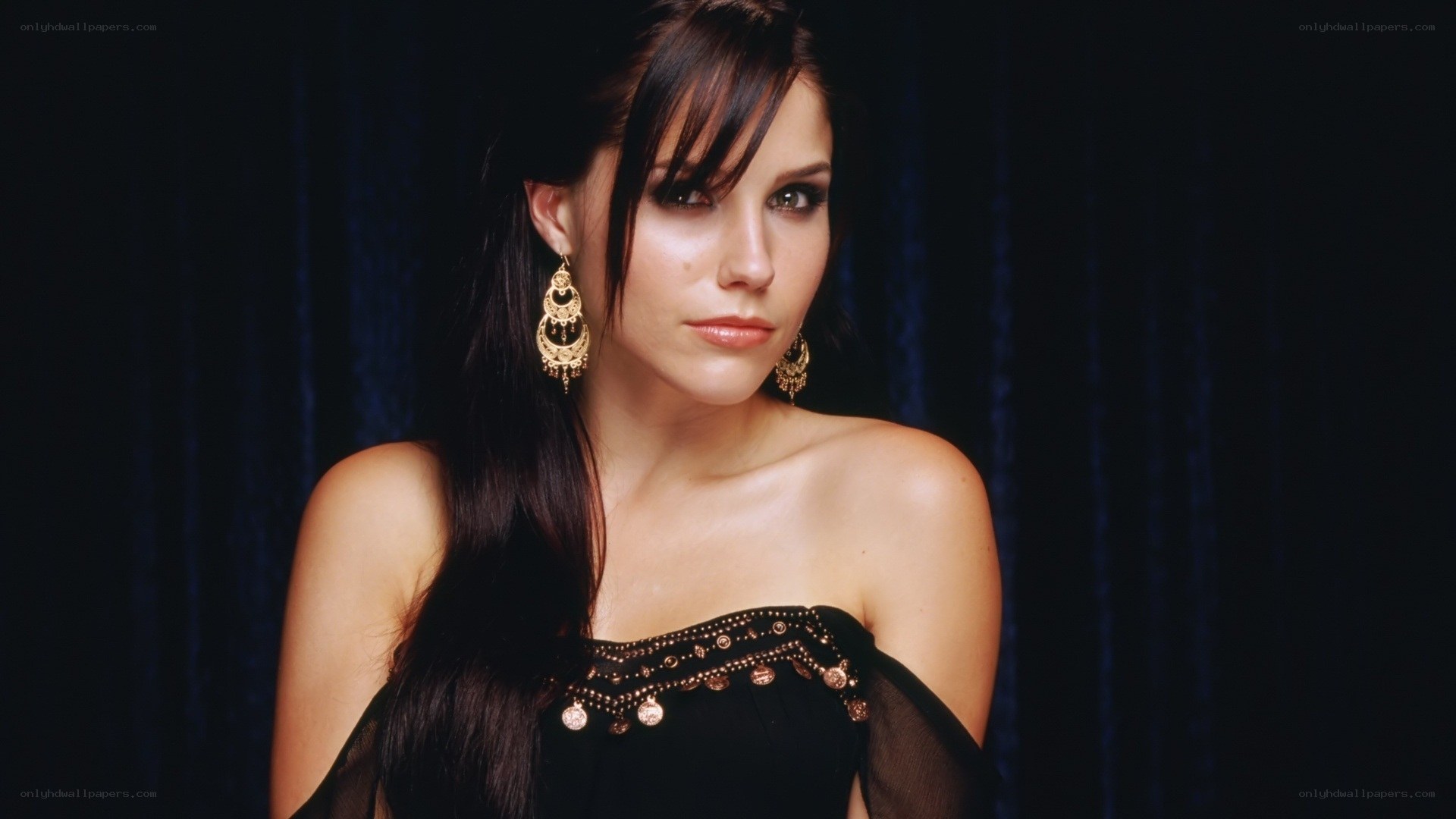 woman in black dress with earrings