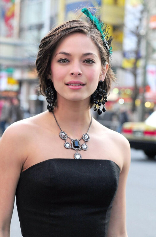 woman in black dress with feather headband