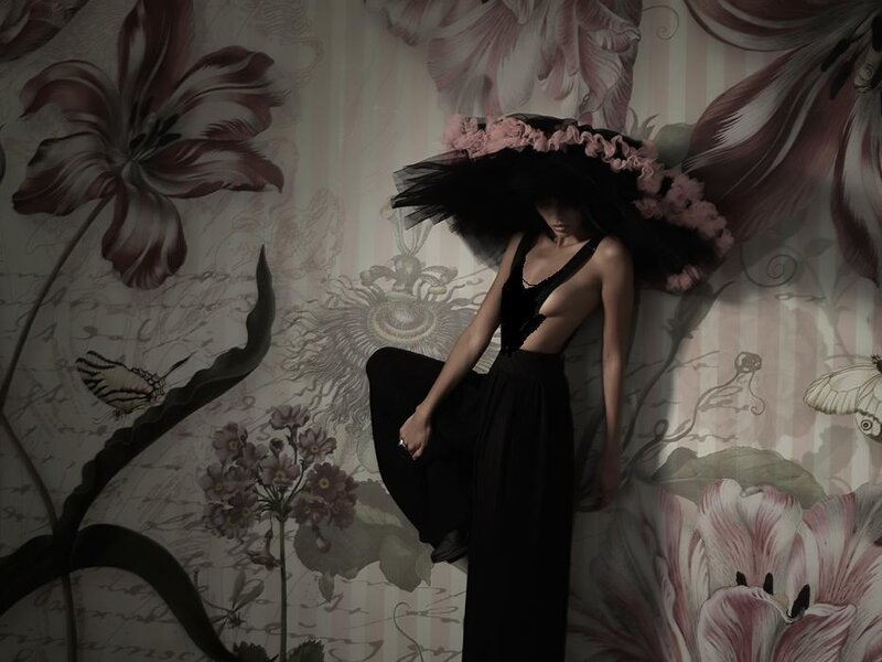 woman in black dress with floral hat