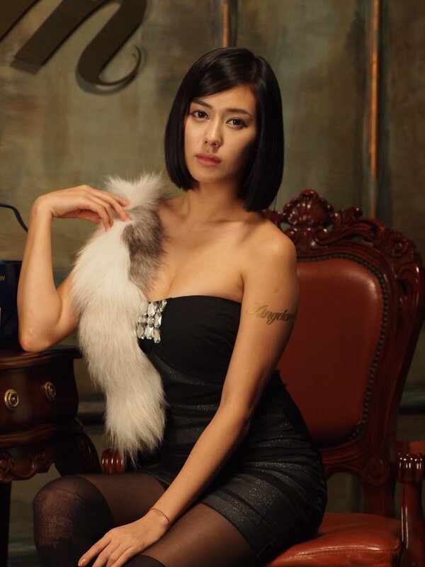 woman in black dress with fur stole