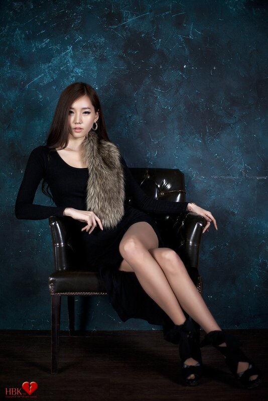 woman in black dress with fur stole