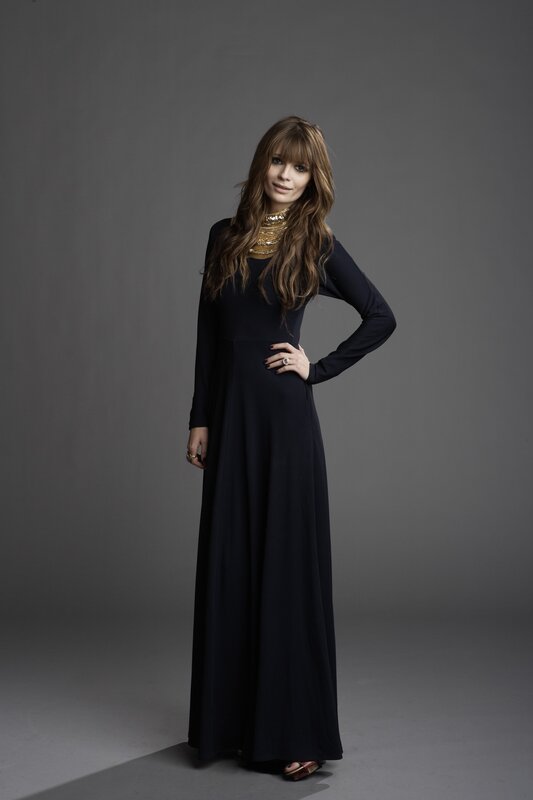 woman in black dress with gold necklace