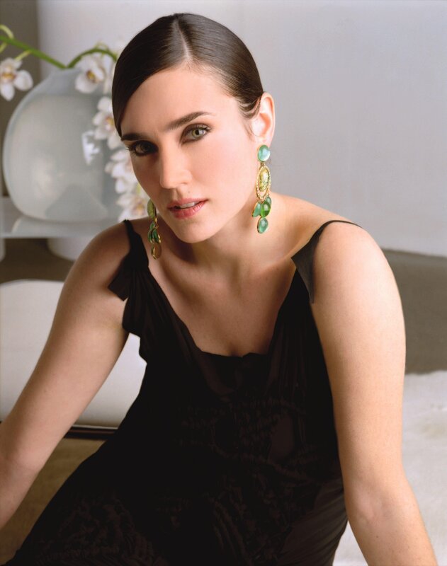 woman in black dress with green earrings