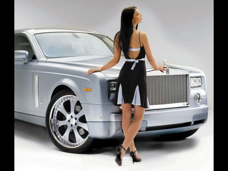 woman in black dress with luxury car